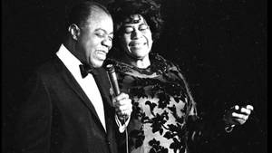 Ella Fitzgerald Performing With Louis Armstrong Wallpaper