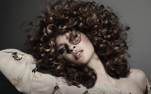 Embrace The Curl — Woman Flaunting Her Luscious Curly Hair. Wallpaper