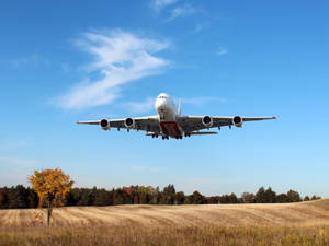 Emirates A380 Flying Over A Farm Wallpaper