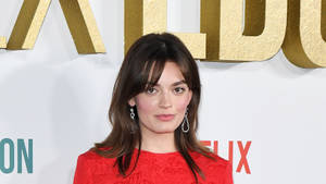 Emma Mackey, Radiant In Red On The Red Carpet Wallpaper