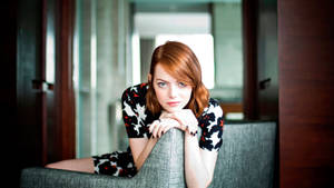 Emma Stone On Grey Couch Wallpaper