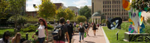 Energized Students Walking Across The Campus Of George Washington University Wallpaper