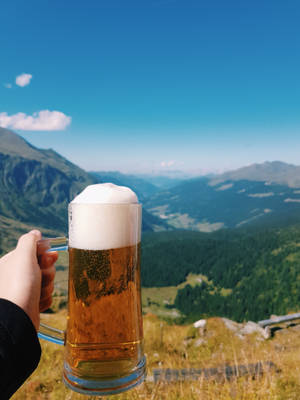 Enjoy A Beer In The Mountains Wallpaper