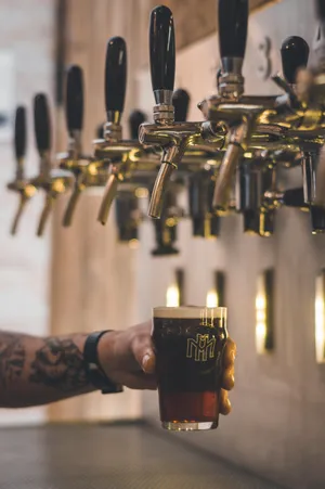 Enjoy A Cold Beer From A Keg Tap Wallpaper