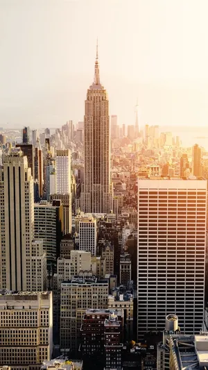 Enjoy A Panoramic View Of The City Skyline During A Spectacular Sunset. Wallpaper