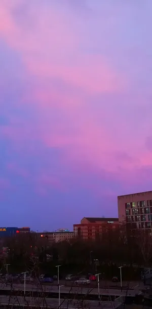 Enjoy The Colorfully Illuminated City During A Sunset Wallpaper