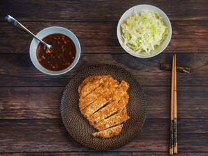 Enjoying A Delicious Plate Of Tonkatsu Wallpaper