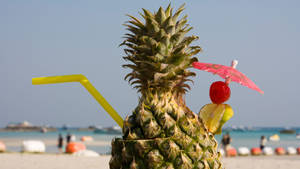 Enjoying A Pineapple Beach Cocktail On A Sunny Day Wallpaper