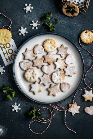 Enjoying Freshly Baked Christmas Cookies Wallpaper