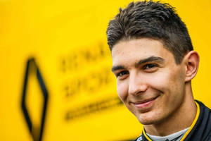 Esteban Ocon Against Blurry Yellow Backdrop Wallpaper