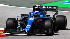 Esteban Ocon In Blue Race Car Wallpaper