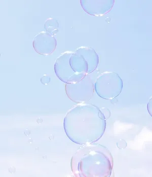 Ethereal_ Soap_ Bubbles_ Against_ Sky Wallpaper