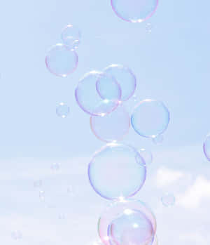 Ethereal_ Soap_ Bubbles_ Against_ Sky Wallpaper