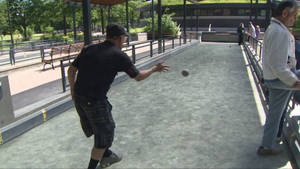 Exciting Moment Of A Bocce Ball Being Thrown On A Court Wallpaper