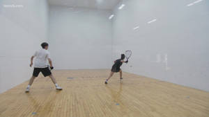 Exciting Moment Of Powerful Return In A 1v1 Racquetball Match. Wallpaper