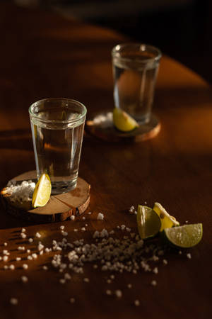 Exquisite Tequila Shots Served With Lime And Salt Wallpaper