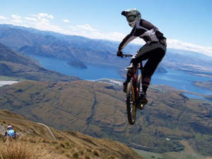 Extreme 4k Mountain Bike Trick With Ocean View Wallpaper