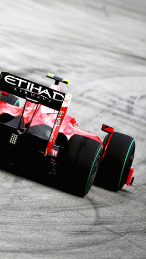 F1 Phone Embracing Speed At The Etihad Red Formula Race Wallpaper