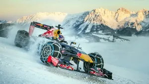 F1 Racing Car In Snow Road Wallpaper
