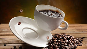 Falling Cup On Coffee Beans Wallpaper