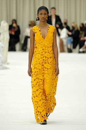 Fashion-forward Elegance With Jil Sander's Yellow Jumpsuit Wallpaper