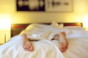 Feet On A White Bed Wallpaper