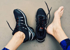 Feet Wearing Black Running Shoes Wallpaper