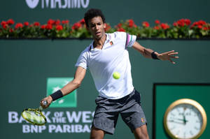 Felix Auger Aliassime Swinging Racket Wallpaper