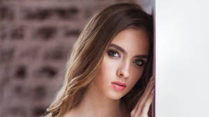 Female Model Leaning On The Wall Wallpaper