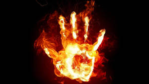 Fire Hand On A Black Background Wallpaper