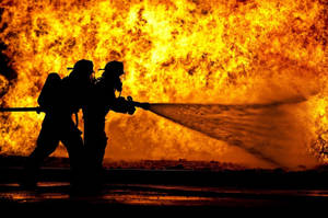 Firefighter In A Grueling Job Wallpaper