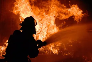 Firefighter Struggling With Strong Fire Wallpaper