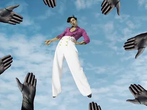 Floating Artist Surroundedby Hands Wallpaper