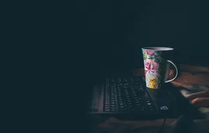 Floral Coffee Mug On Laptop Wallpaper