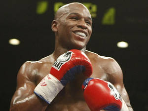 Floyd Mayweather Smiling Red Boxing Gloves Wallpaper