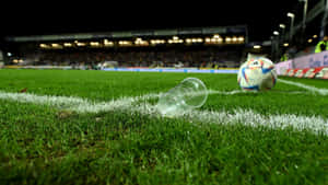 Football Field With Soccer Ball And Plastic Cup Wallpaper