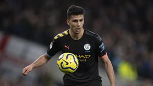 Footballer Rodri With Ball Focus Shot Wallpaper