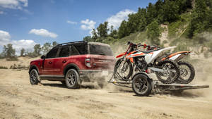 Ford Bronco With Two Dirt Bikes Wallpaper