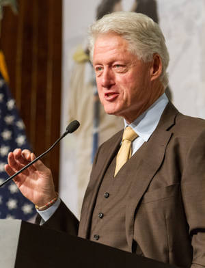 Former President Bill Clinton In Elegant Brown Tuxedo Wallpaper