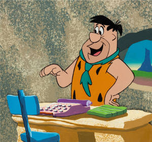 Fred Flintstone At Office Desk Comic Wallpaper