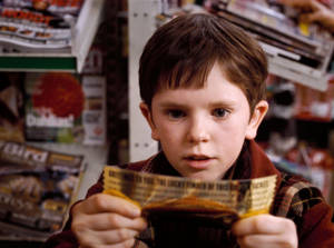 Freddie Highmore With Golden Ticket Wallpaper