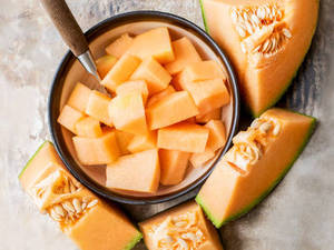 Fresh Cantaloupe In A Ceramic Bowl Wallpaper