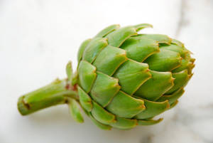 Fresh Green Artichoke In Natural Environment Wallpaper