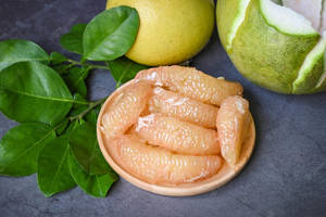 Fresh Pomelo On Wooden Table Wallpaper