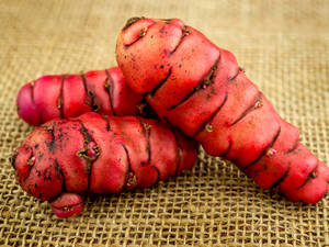 Fresh Red Yam On Brown Cloth Wallpaper