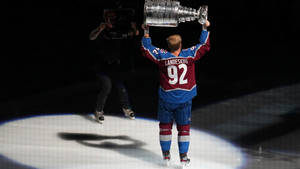 Gabriel Landeskog Hoisting The Stanley Cup In 2022. Wallpaper