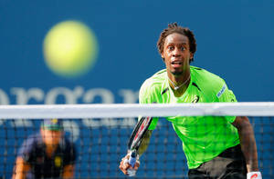 Gael Monfils In Action At A Professional Tennis Match Wallpaper