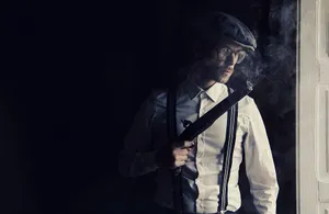 Gangster With Guns Wearing Vintage Outfit Wallpaper
