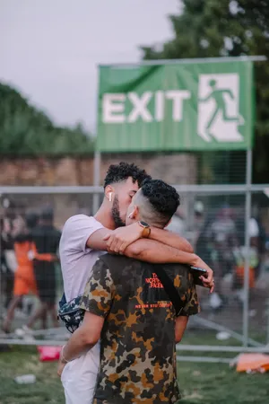 Gay Couple Kissing In Crowd Wallpaper