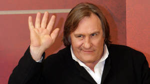 Gérard Depardieu Waving Pink Background Wallpaper